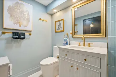Bathroom #1 features a large standing tile shower, shampoo, body wash, conditioner, and clean towels.