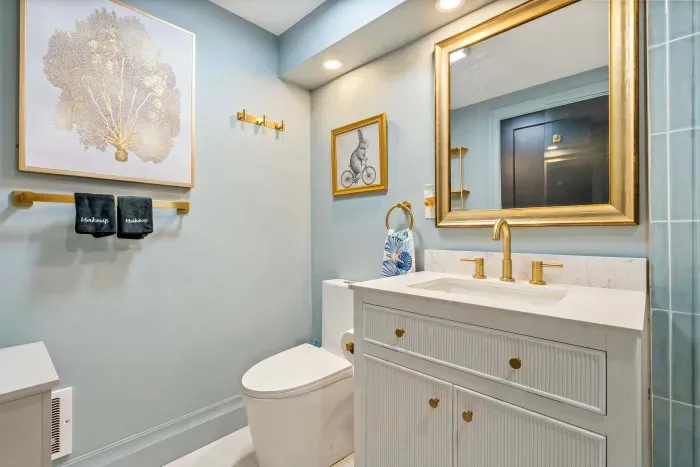 Bathroom #1 features a large standing tile shower, shampoo, body wash, conditioner, and clean towels.