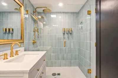 Bathroom #1 features a large standing tile shower, shampoo, body wash, conditioner, and clean towels.