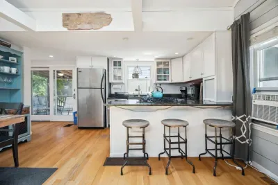 Fully equipped kitchen with all necessary appliances, 3-seater eat-in counter, and 6-person dining table