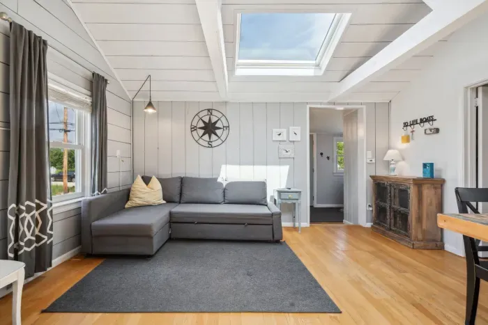 Living room area with smart TV and sectional, queen sized, sleeper sofa