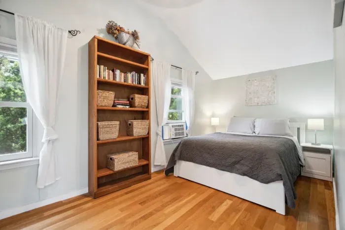 Primary bedroom with queen bed and closet