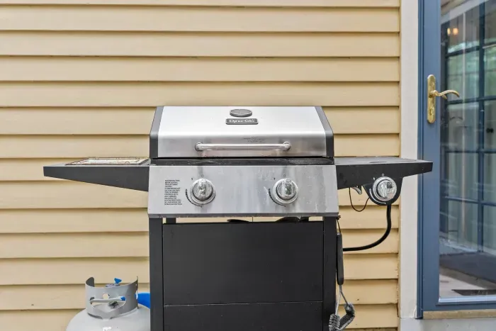 Deck off the main house with gas grill