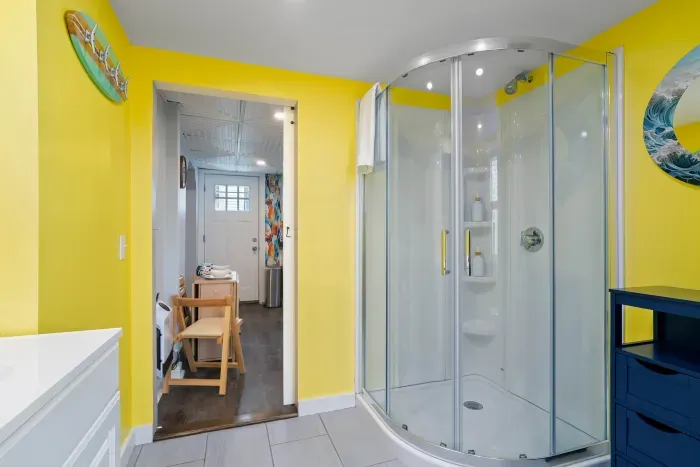 Bathroom #1, on the 1st floor, with stand up shower. Bathroom can be accessed via kitchen and via primary bedroom.
