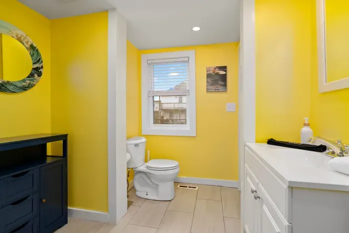 Bathroom #1, on the 1st floor, with stand up shower. Bathroom can be accessed via kitchen and via primary bedroom.