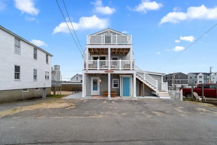 Exterior of property. This Property comes with 4 off-street parking spots (parked side-by-side in the driveway), has several private decks (front and back), along with fun and relaxing ground-level outdoor spaces.