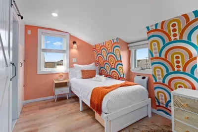 Bedroom #4 (3rd floor) with two twin beds, mounted smart TV and ensuite bathroom with walk-in tiled shower.