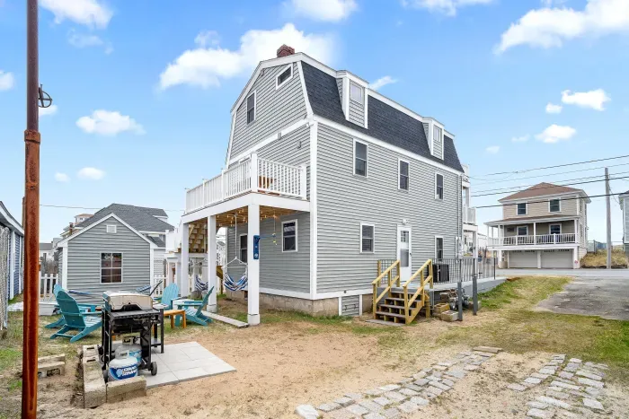 Common back yard area, with common amenities shared with the unit upstairs -- string lights, gas firepit, sitting area, hammock, swinging chairs - WE NO LONGER HAVE A GRILL
