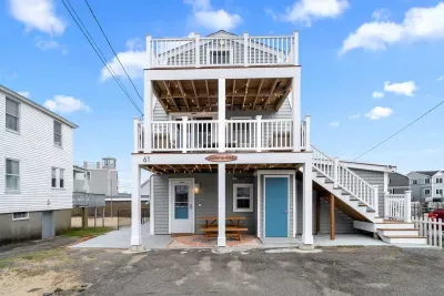 Exterior of property. This Property comes with 4 off-street parking spots (parked side-by-side in the driveway), has several private decks (front and back), along with fun and relaxing ground-level outdoor spaces.