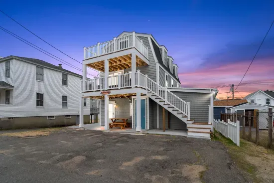 Exterior of property. This Property comes with 4 off-street parking spots (parked side-by-side in the driveway), has several private decks (front and back), along with fun and relaxing ground-level outdoor spaces.