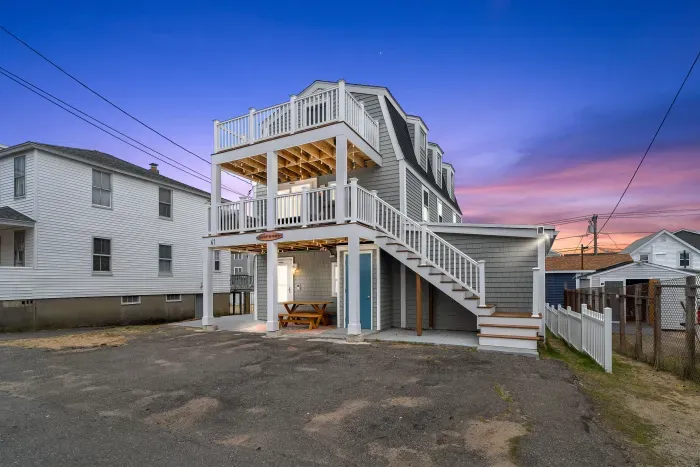 Exterior of property. This Property comes with 4 off-street parking spots (parked side-by-side in the driveway), has several private decks (front and back), along with fun and relaxing ground-level outdoor spaces.