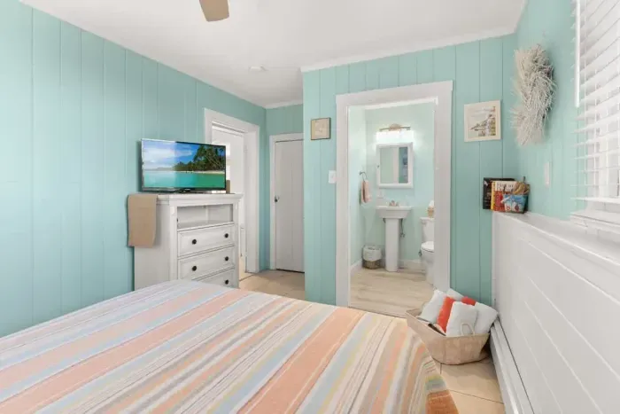 Master bedroom, queen-sized bed, attached 1/2 bathroom and smart Roku TV