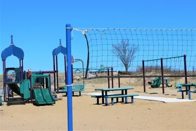 This beach volleyball court, children's playground and 1/2 basketball court is located right outside the back entrance of the rental.