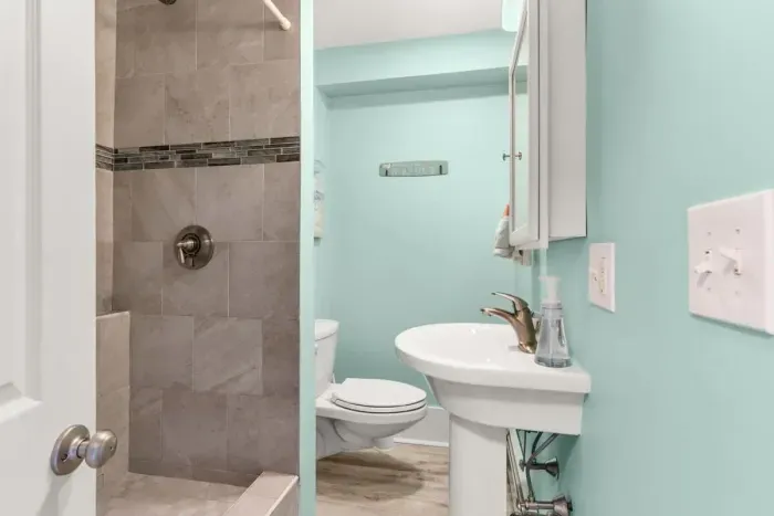 Full bathroom with tiled shower (no tub)