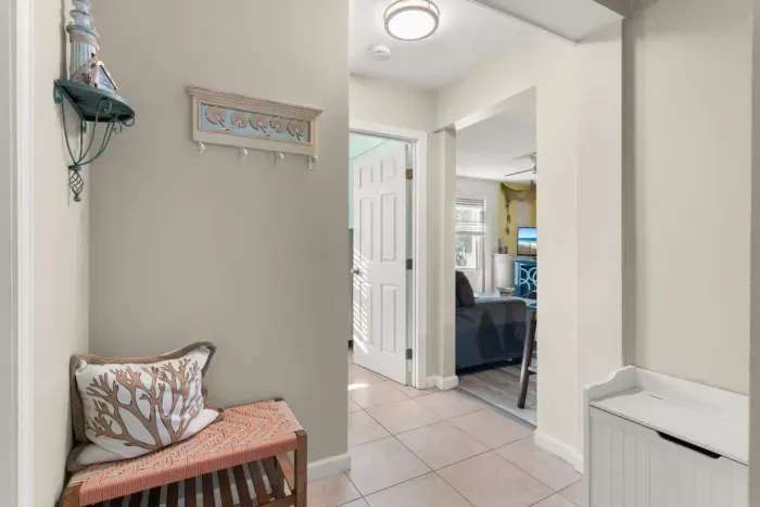 Hallway accessing all 3 bedrooms and living room/kitchen