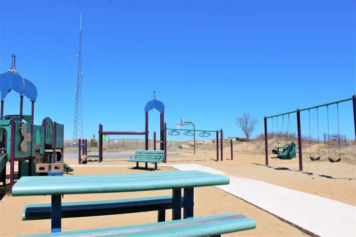 This beach volleyball court, children's playground and 1/2 basketball court is located right outside the back entrance of the rental.