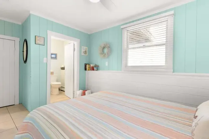 Master bedroom, queen-sized bed, attached 1/2 bathroom and smart Roku TV