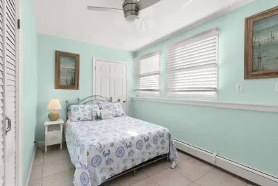 Second of three bedrooms, full-sized bed, beautiful natural light, plenty of closet space and storage.
