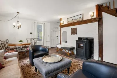 Living room with smart TV, books, games, comfortable seating and strong WiFi. The woodstove is inoperable and not to be used.