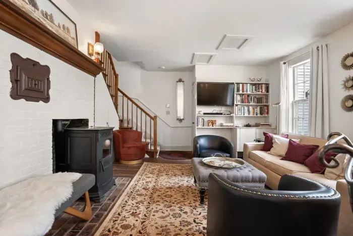 Living room with smart TV, books, games, comfortable seating and strong WiFi. The woodstove is inoperable and not to be used.
