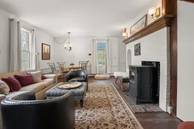 Living room with smart TV, books, games, comfortable seating and strong WiFi. The woodstove is inoperable and not to be used.