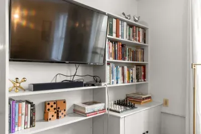 Living room with smart TV, books, games, comfortable seating and strong WiFi. The woodstove is inoperable and not to be used.