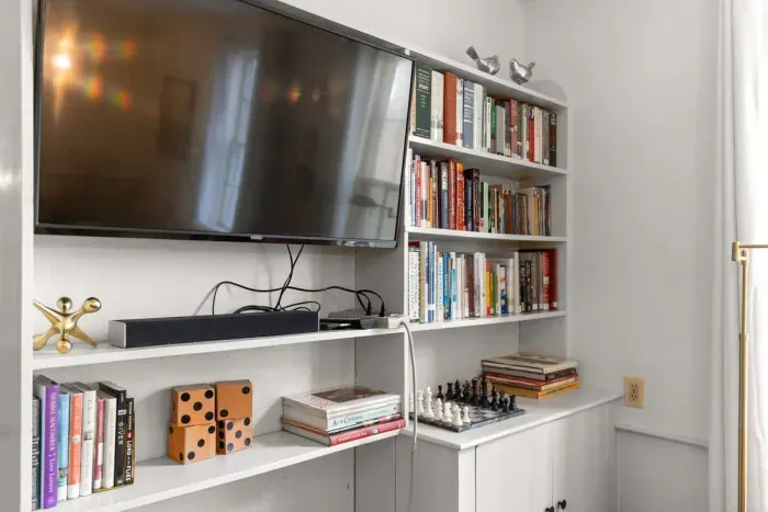 Living room with smart TV, books, games, comfortable seating and strong WiFi. The woodstove is inoperable and not to be used.