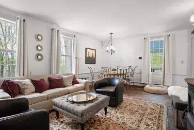 Living room with smart TV, books, games, comfortable seating and strong WiFi. The woodstove is inoperable and not to be used.