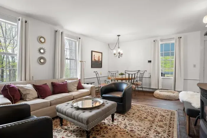 Living room with smart TV, books, games, comfortable seating and strong WiFi. The woodstove is inoperable and not to be used.