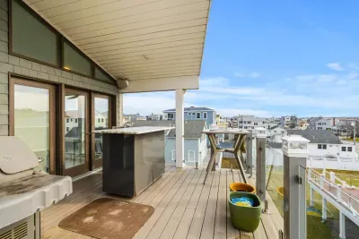 The back rooftop deck overlooking the Salisbury marsh. More breathtaking sunsets and water views back here :). Please note this grill up here is for owner use only.