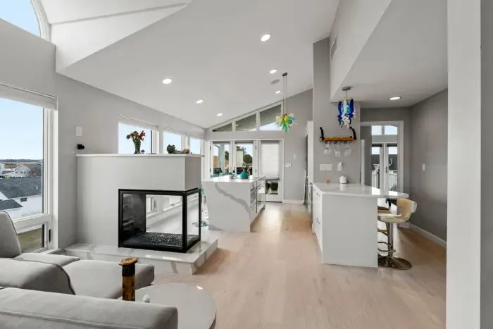 View of the fully equipped kitchen, gas fireplace, and access to the second Queen bedroom. 
