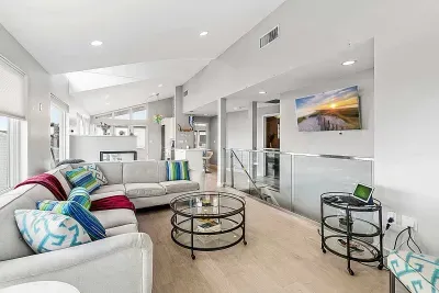 Top floor penthouse living room with breathtaking ocean views, smart TV, gas fireplace, and two rooftop decks