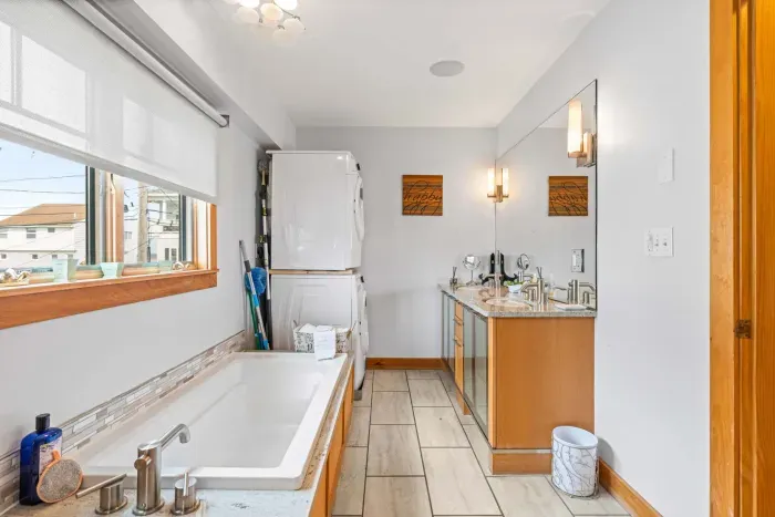 The Yoga unit has dual vanities, a washer and dryer, soaking tub, and a tiled shower. Clean towels provided for all guests. 