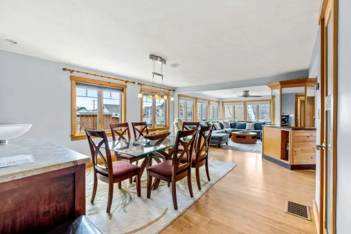 Dining area in the Namaste unit with seating for 6. Wet bar is located behind it with a sink and 2 drink fridges. There is extra drink wear in the glass door cabinet.
