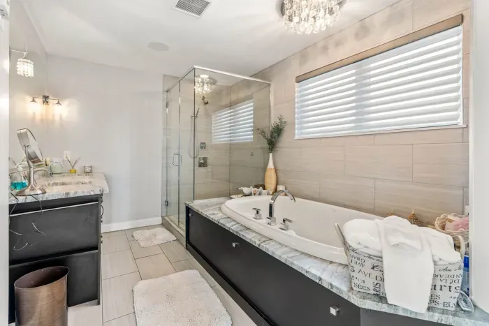 Luxurious bathroom with soaking tub, dual vanity and stunning tiled shower. Clean towels provided for all guests.
