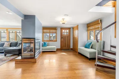 🛋️ Namaste Unit Living Room – Bright and spacious with hardwood floors, cozy seating, smart TV, and a modern double-sided fireplace. The spiral staircase adds a unique touch, making it the perfect spot to relax or gather with family and friends.