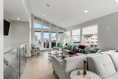 Top floor penthouse living room with breathtaking ocean views, smart TV, gas fireplace, and two rooftop decks