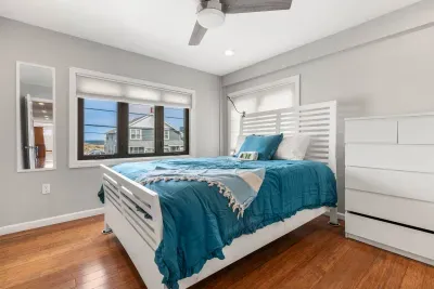 Nautical unit Queen bedroom with a smart TV and clean provided linens. Wake up to ocean views out your window!