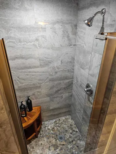 The fully renovated Namaste bathroom with River rock tile! Clean towels provided for all guests. 