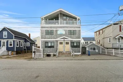 The Commonwealth Ave side of the building. Parking for 2 cars in front of the rope. Please leave the parking in front of the cottage for the owner.