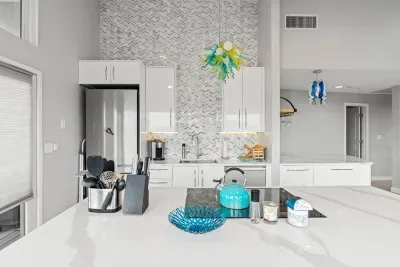 Fully renovated and equipped kitchen with high end Miele appliances, induction stove top, stunning full length backsplash, and seating for 4 at the island (+2 at the peninsula).