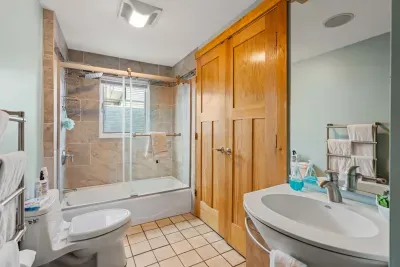 Namaste bathroom with Washer and Dryer, and shower/tub combo. Towel warmer with clean towels for all guests.