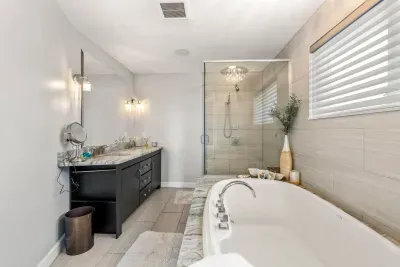 Luxurious bathroom with soaking tub, dual vanity and stunning tiled shower. Clean towels provided for all guests.