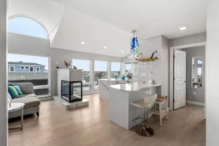 Fully renovated and equipped kitchen with high end Miele appliances, induction stove top, gas fireplace, and seating for 4 at the island (+2 at the peninsula).

