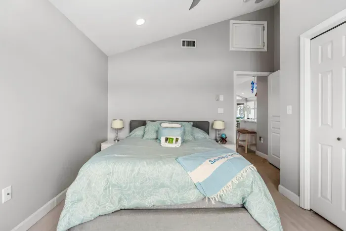 The second bedroom in the penthouse with a queen bed and clean provided linens