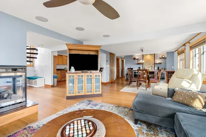 🛋️ Namaste Unit Living Room – Bright and spacious with hardwood floors, cozy seating, smart TV, and a modern double-sided fireplace. The spiral staircase adds a unique touch, making it the perfect spot to relax or gather with family and friends.