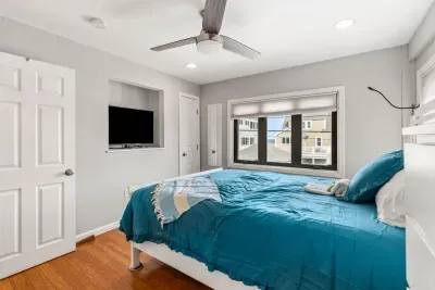 Nautical unit Queen bedroom with a smart TV and clean provided linens. Wake up to ocean views out your window!