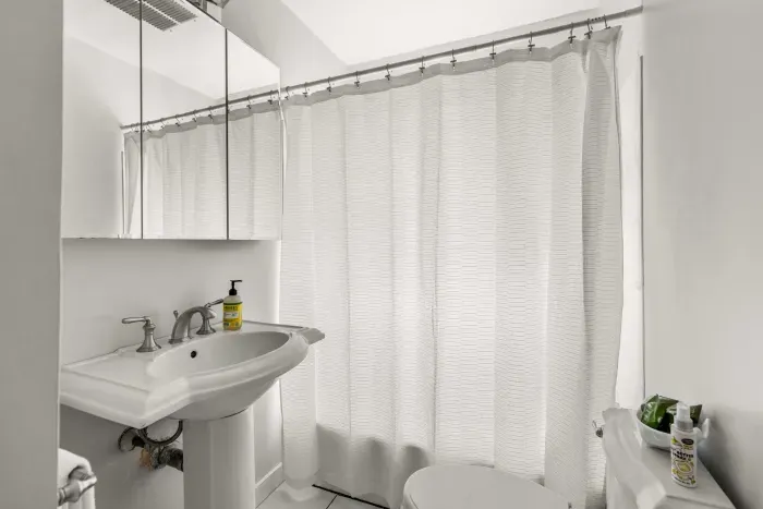 Nautical bathroom with a shower and tub combo. Clean towels provided for all guests. 