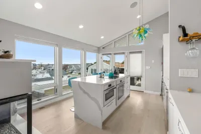 Fully renovated and equipped kitchen with high end Miele appliances, induction stove top, and seating for 4 at the island (+2 at the peninsula).