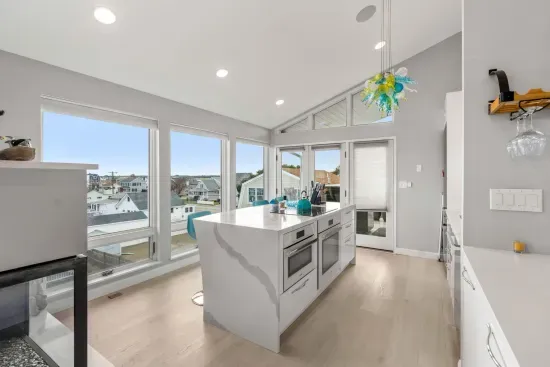 Fully renovated and equipped kitchen with high end Miele appliances, induction stove top, and seating for 4 at the island (+2 at the peninsula).